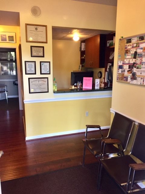 Waiting area with framed credentials on the wall